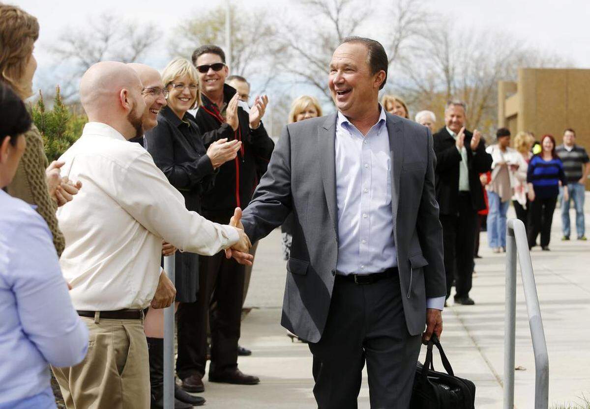 Former PNNL Director Mike Kluse shakes hands with staff at the lab in Richland.
