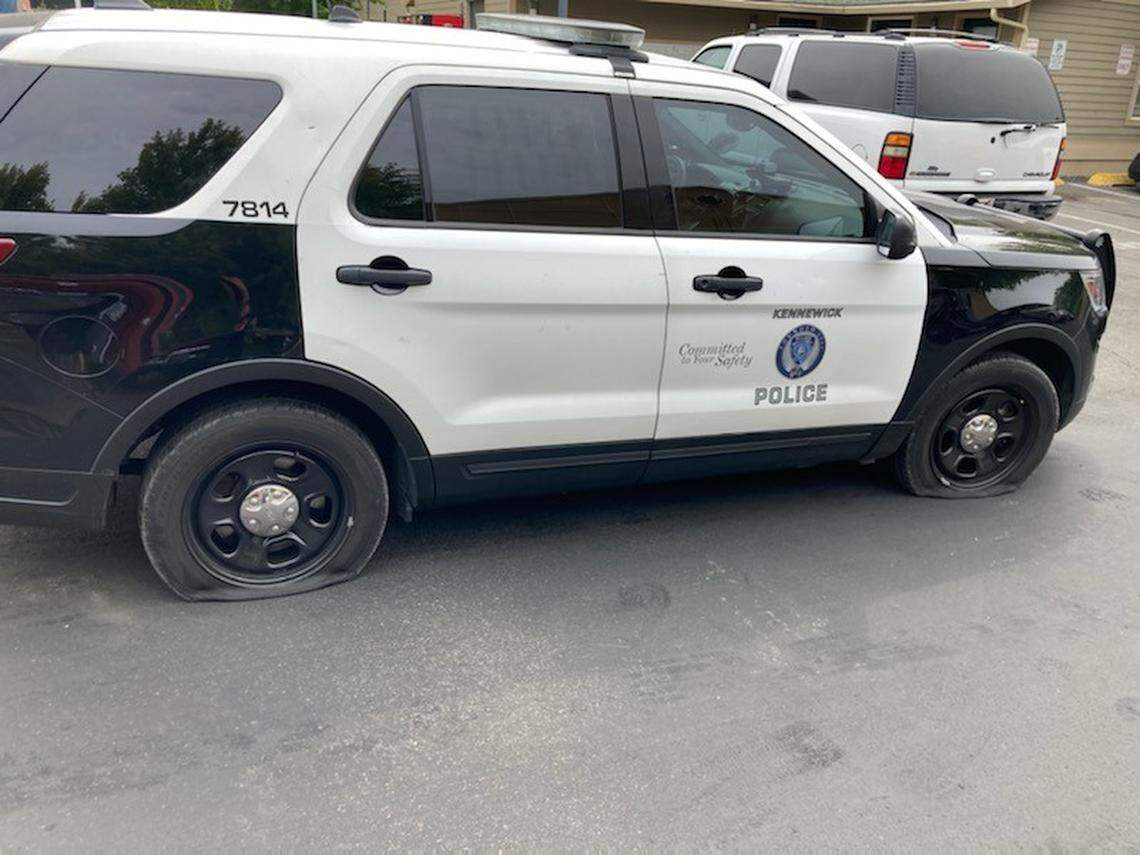 A Kennewick woman is in jail after stabbing nine tires across three patrol cars in Kennewick,