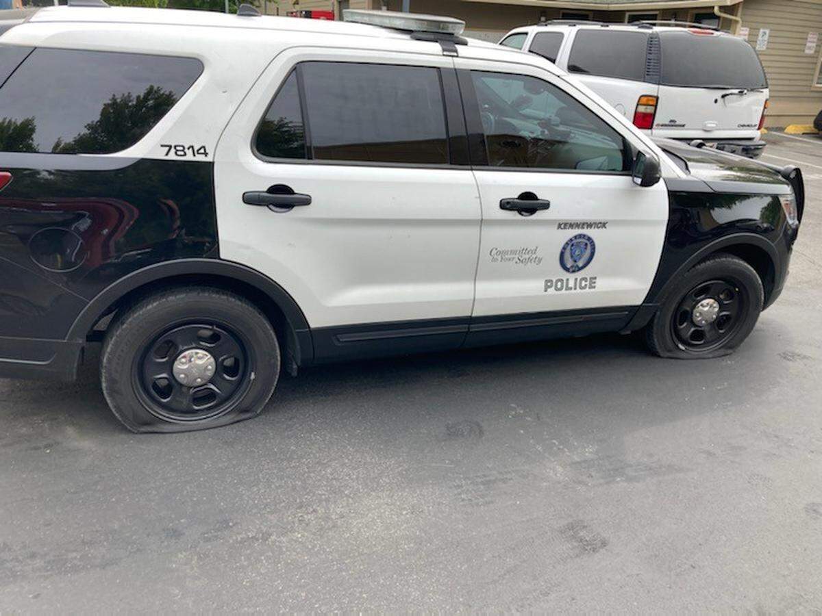 A Kennewick woman is in jail after stabbing nine tires across three patrol cars in Kennewick,