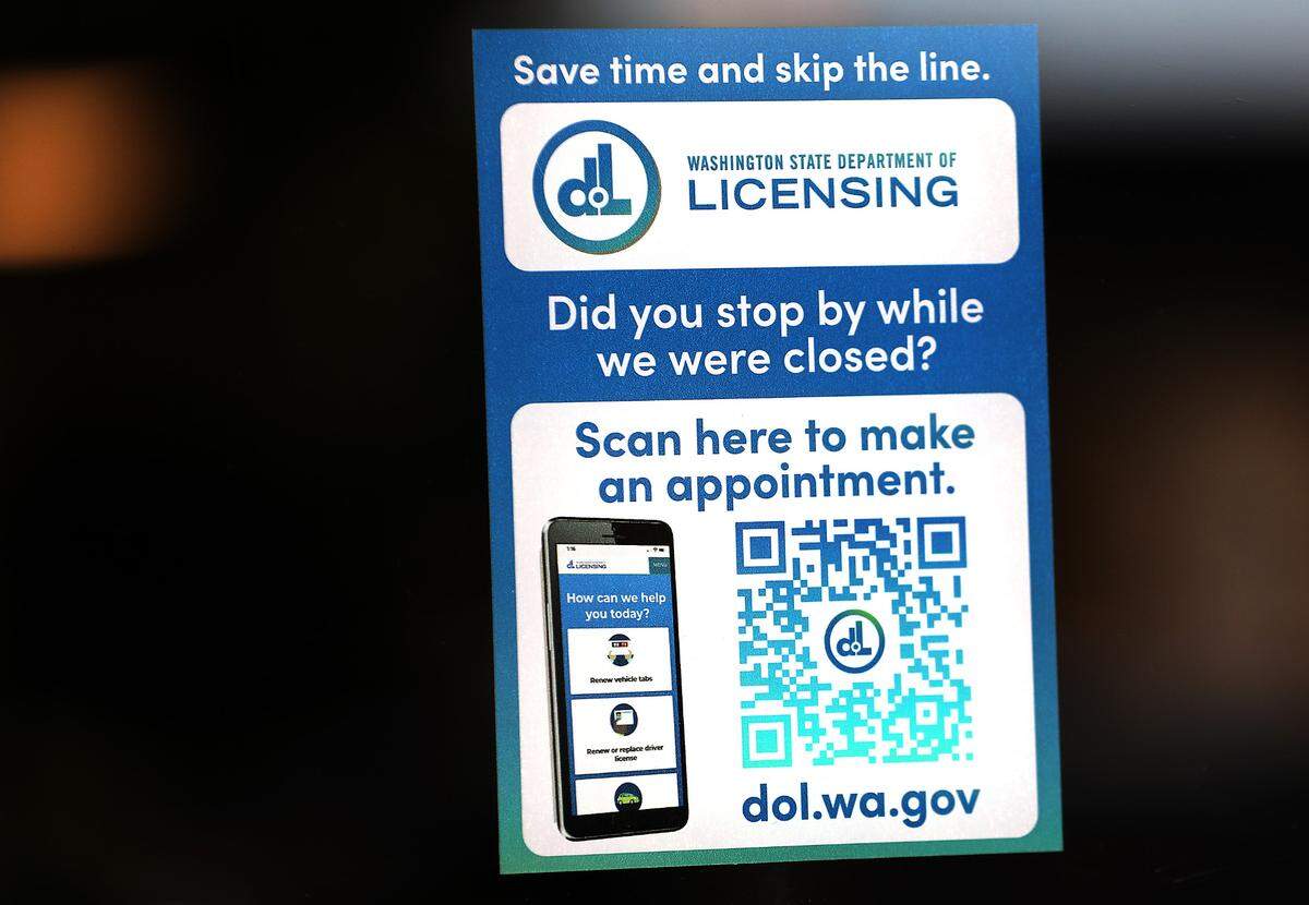 Sign with QR code for online appointment on front window of the Washington State Department of Licensing Drive Licensing office at 3311 W. Clearwater Ave. in Kennewick.