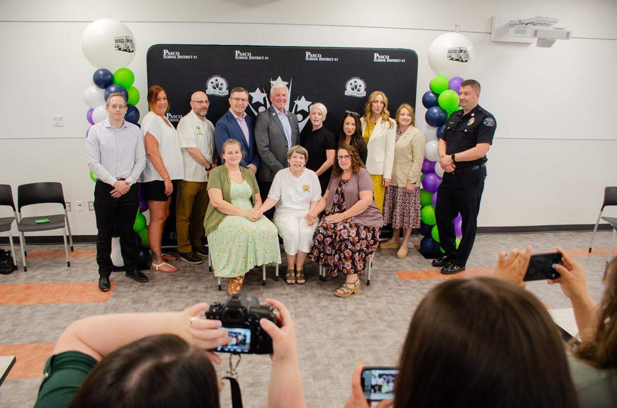Pasco School District officials, Tri-City lawmakers and police pose for photos during a May 16 event celebrating the Richard Lenhart Act being signed into law.