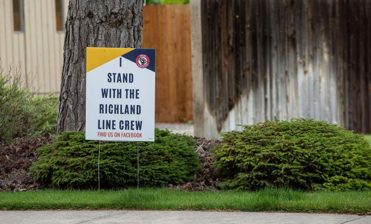 A large sign asking the community to support Richland’s electrical line workers is prominently displayed along George Washington Way in Richland. Contract with the city have been stuck in mediation for months.