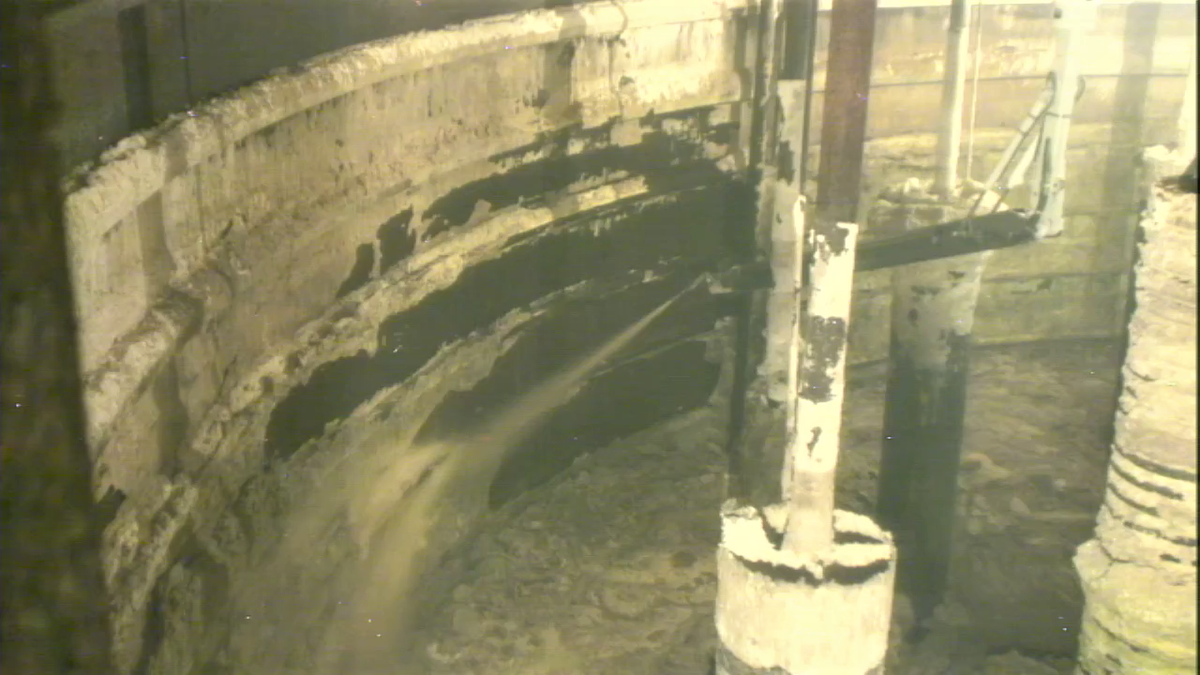 The water stream from one of three sluicers installed in Hanford Tank AX-101 is used to remove waste from tank walls during recently started work to empty the tank.