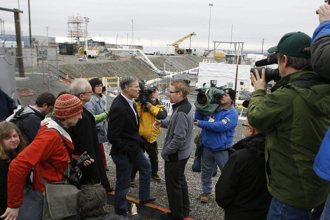 Washington Gov. Jay Inslee, center, is shown surrounded by news reporters and Hanford officials during a visit to the tank farms at the nuclear reservation in 2013.