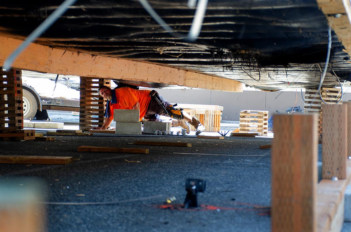 Kraig Richardson, lead worker with T&S Modular, prepares the underside of a portable for installation at Chiawana High School for fall semester.