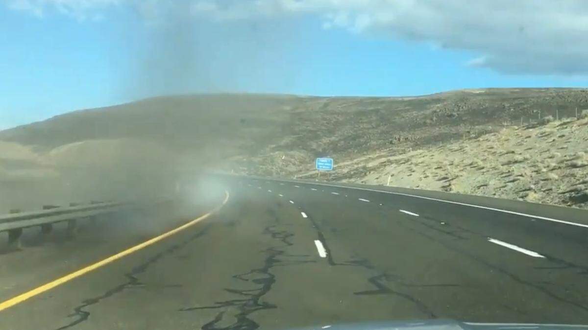 Interstate 90 is closed because of a fire sending smoke and dust across the highway.