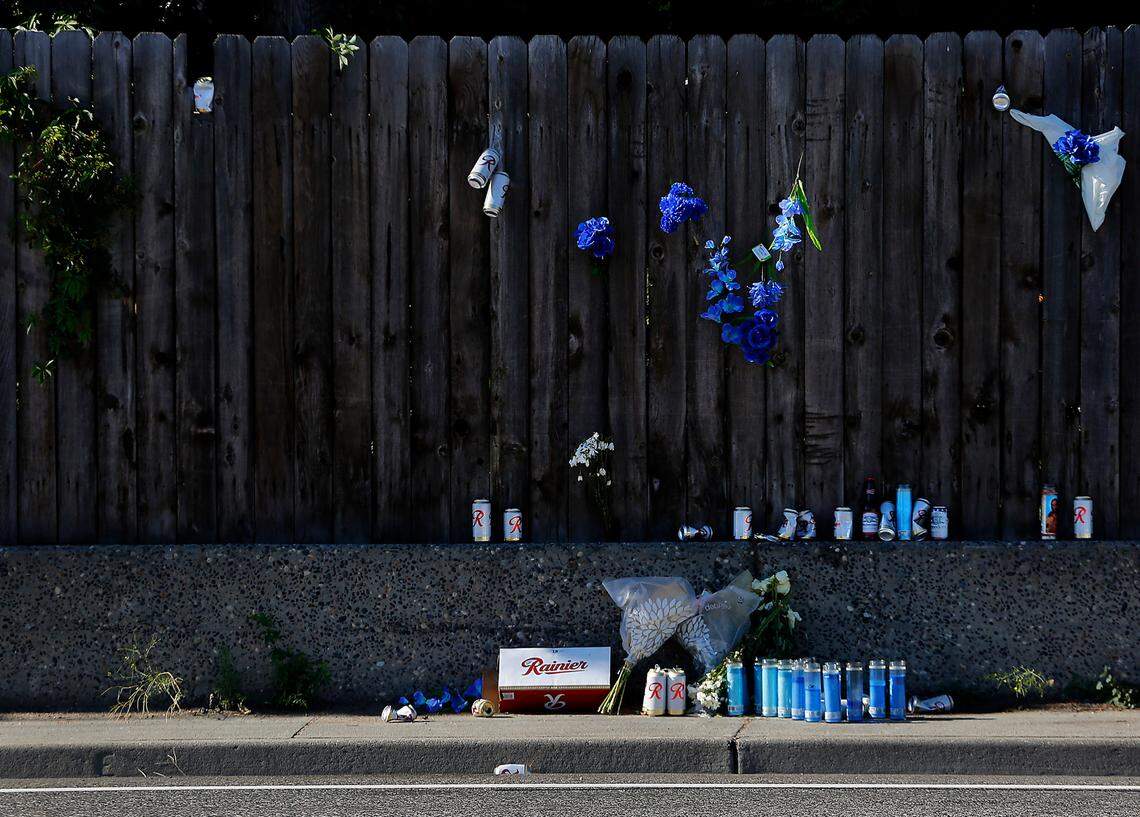 An impromptu memorial of beer, candles, flowers and a cigar has been left on the sidewalk and fence near the site where Jordan Patrick Taylor, 30, of Pasco was fatally shot July 14, 2022 on West Clearwater Avenue near South Kellogg Street in Kennewick. Police investigators say the incident was a motorcycle gang-related shooting.