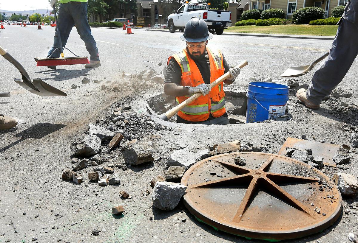 A crew from Total Site Services works on the first phase of the George Washington Way pavement project between Van Giesen and Sprout Streets in north Richland. They are lowering the utility covers in preparation for asphalt grinding scheduled to begin on July 16. Motorists can expect various lane closures and congestion during the work.