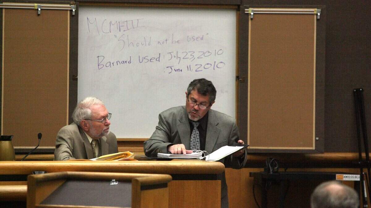 Former Richland psychologist Philip Barnard, left, is shown in this October 2010 photo going over a transcript of police questioning in the trial of Phiengchai Sisouvanh Synhavong who was accused of murder. Barnard died March 20.