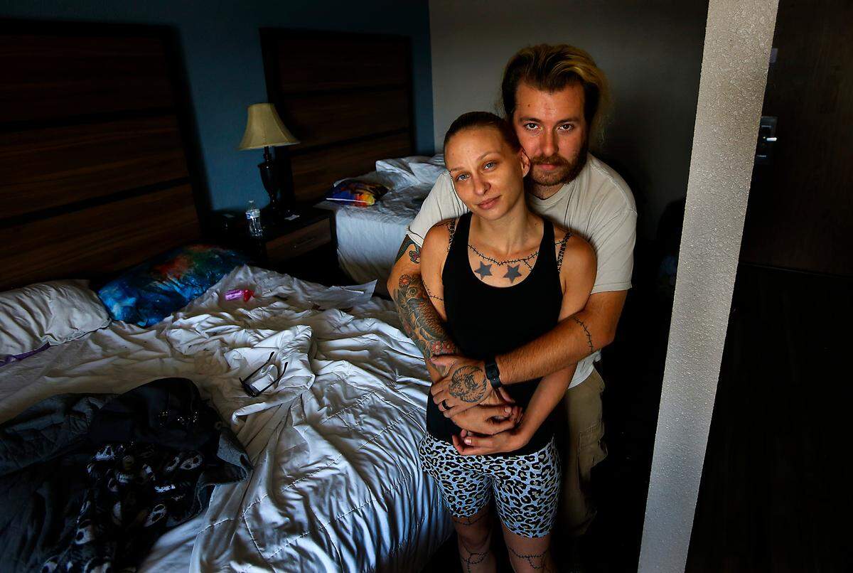 Becca and Danny Glasscock prepare to pack their belongings and check out of a Kennewick motel they were staying at when they ran out of money before the month ended.