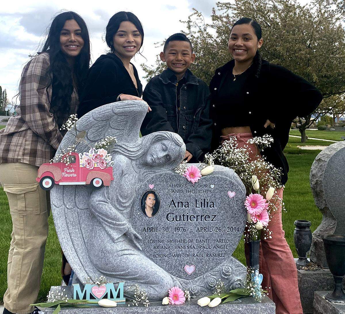 Siblings Vanessa Ramirez, Ariana Ramirez , Raul Angel Ramirez, and Yarelly Ramirez, from left, stand at the grave marker for their mother, Ana Gutierrez-Ramirez, who died in child birth in 2014.