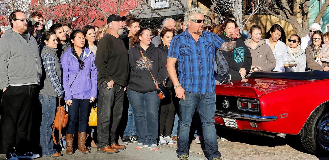 Chef Guy Fieri is surrounded by crew members and fans after a Richland recording of his Food Network television show called Diners, Drive-Ins & Dives.