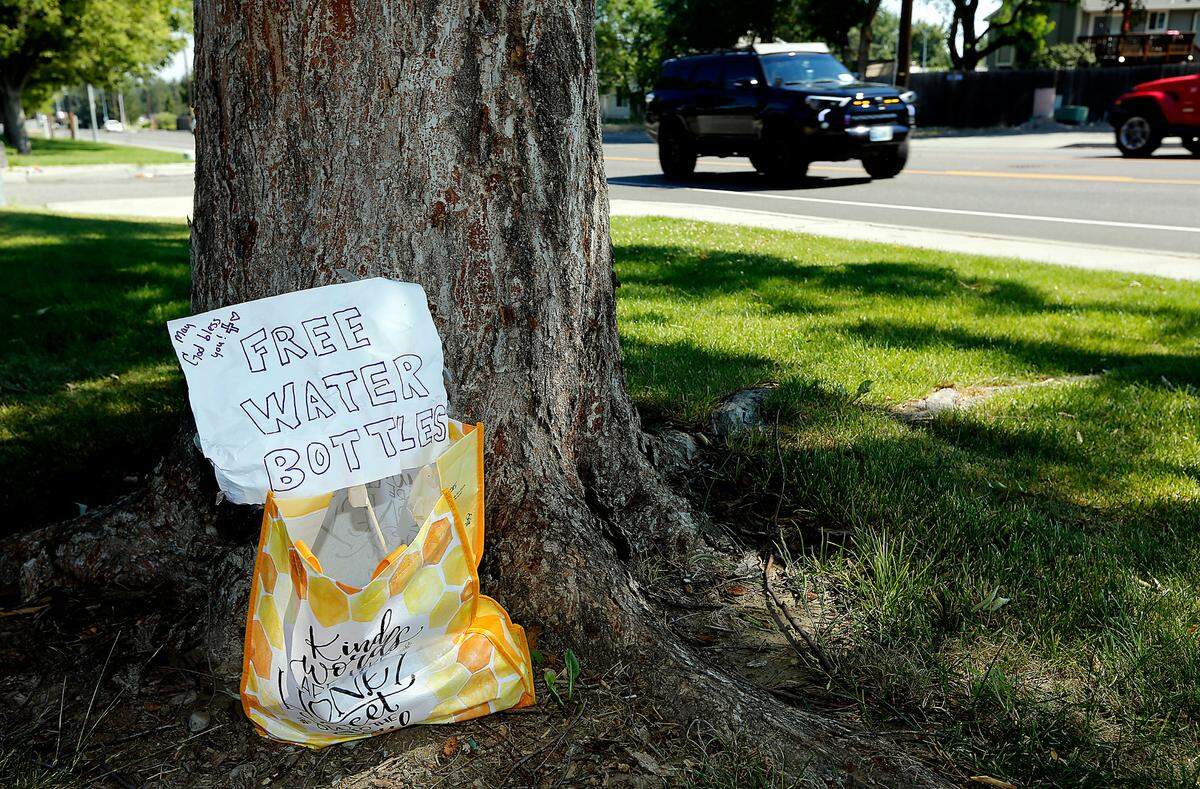 A Good Samaritan left this sign and a bag of water bottles for community members near the Highlands Grange Park on South Union Street in Kennewick during the blistering high temperatures across the Pacific Northwest.