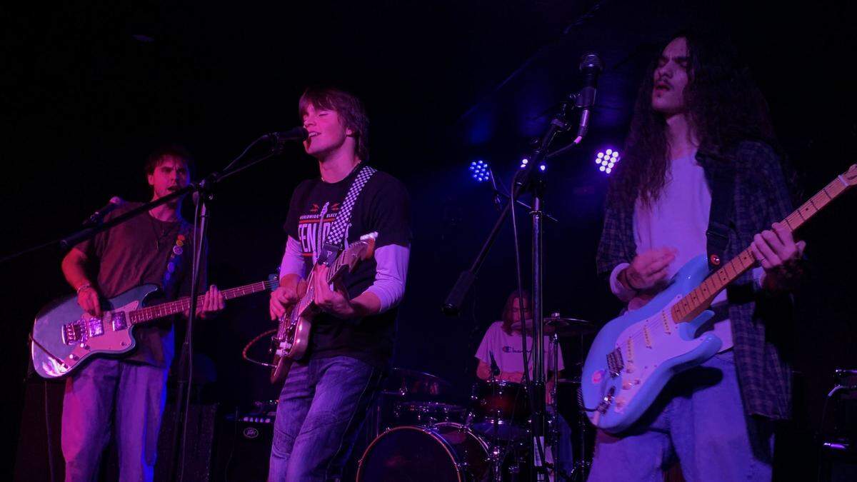 The four members of easyday, bassist Griffin Durham (left), lead vocalist and rhythm guitarist Chase Krank (center), drummer James Bruce (back) and lead guitarist Luke Vesely (right) at a concert at Ray’s Golden Lion on Nov. 3, 2023.