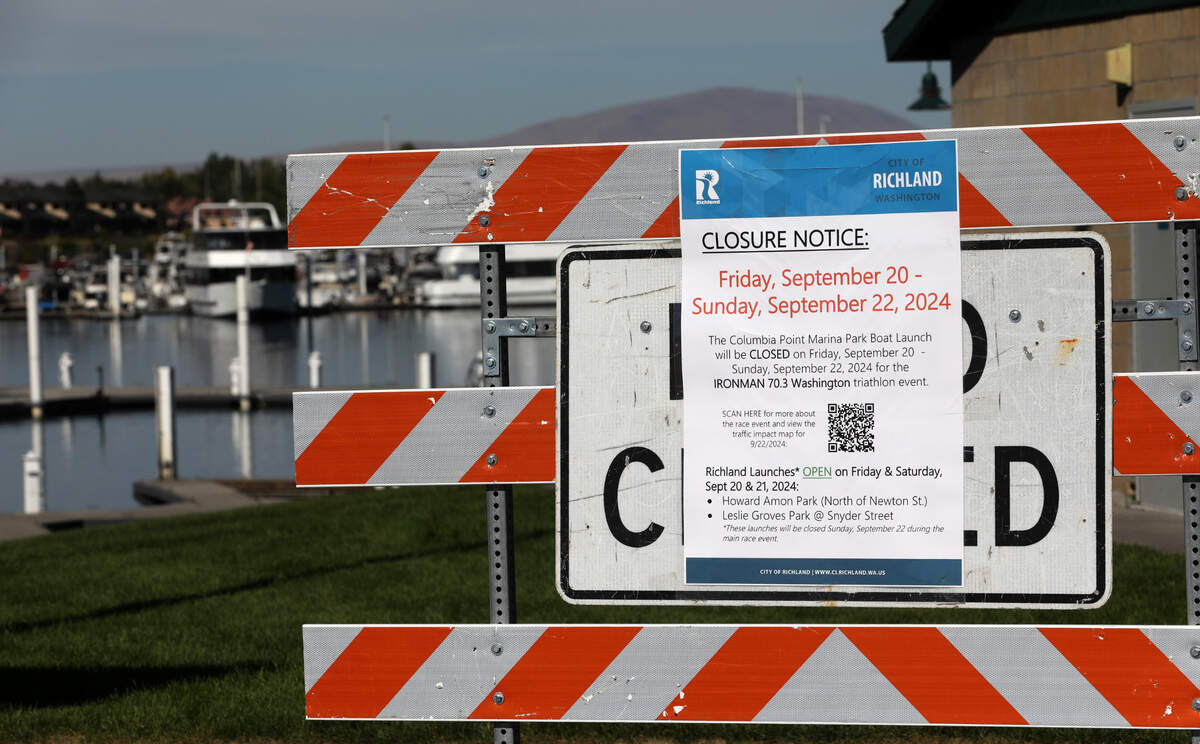 A closure notice for the Ironman event is posted at the boat launch at the Columbia Point Marina Park in Richland.