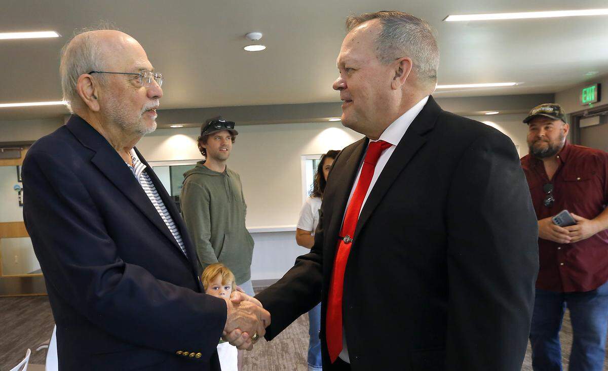 Matt Boehnke, right, is greeted by retired Congressman Richard "Doc" Hastings on Monday upon arriving at the Benton County Elections Center in Kennewick to file for 4th District Congressional race.