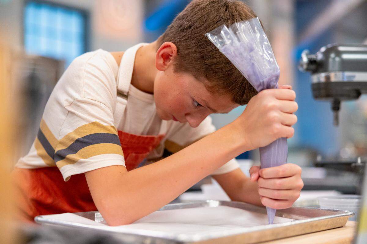 “Kids Baking Championship” contestant Jack Whalen, 13, of West Richland, concentrates on his piping process on the show’s 13th season.