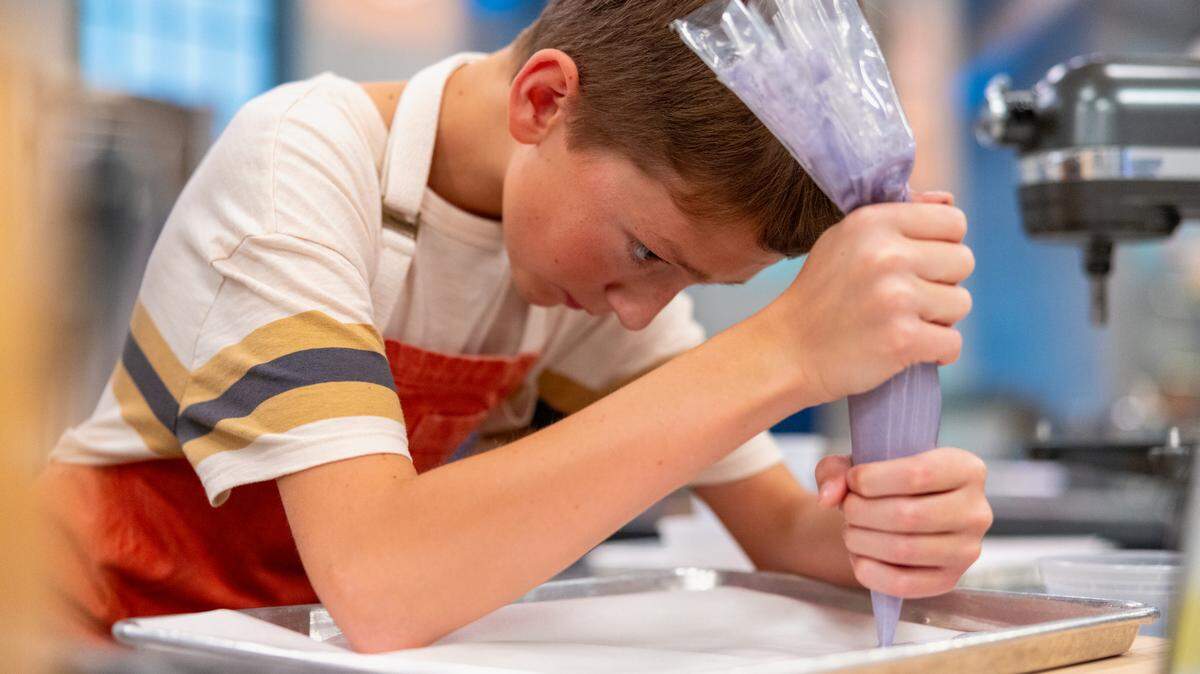 “Kids Baking Championship” contestant Jack Whalen, 13, of West Richland, concentrates on his piping process on the show’s 13th season.