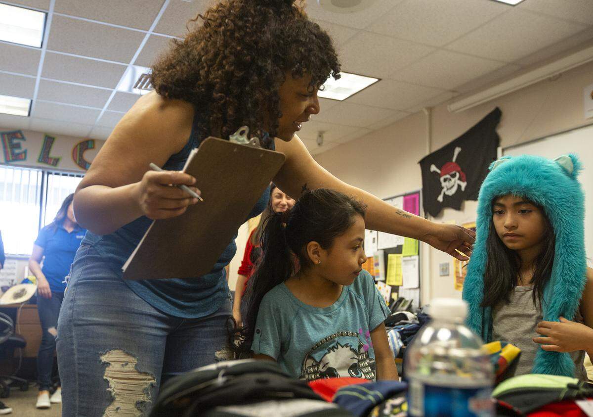 Reka Robinson delivers clothes to students at Virgie Robinson Elementary School in Pasco on Friday after doing her annual clothing drive with HAPO Community Credit Union. Reka, a Power 99.1’s radio personality, is Virgie Robinson’s granddaughter.