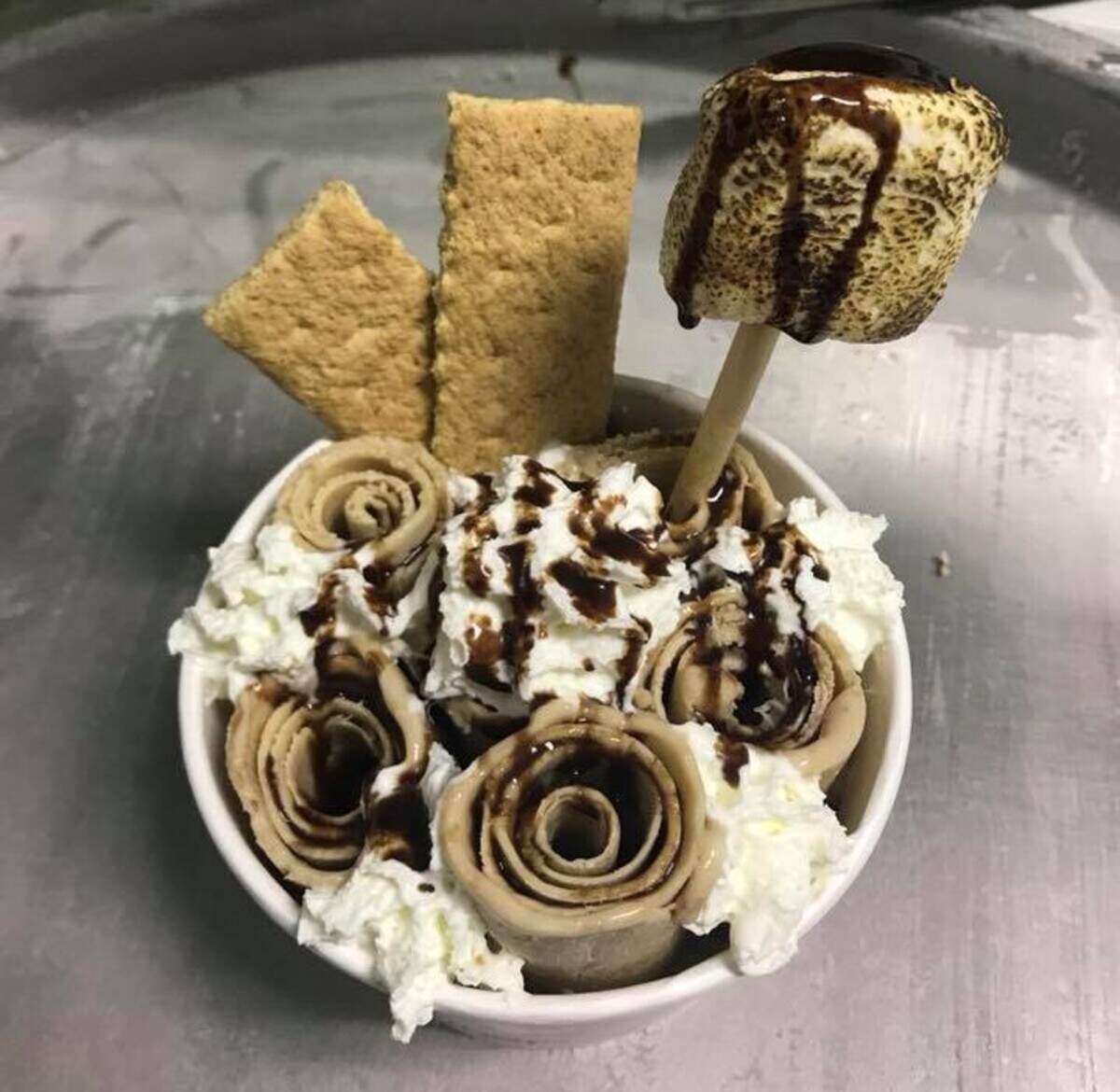 Crepes N Rolls in Pasco has a dish inspired by a campfire s’more - rolled ice cream with in-house toasted marshmallows, graham crackers, chocolate syrup and whipped cream.