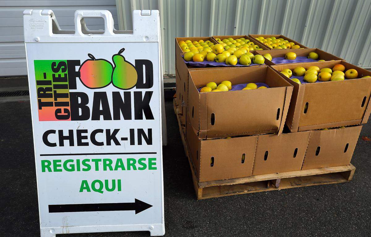 A pallet covered with boxes of apples sits outside the Tri-Cities Food Bank in downtown Kennewick.