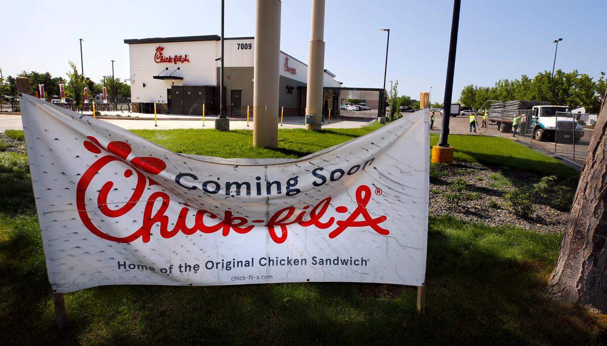 A crew from Emerald City Statewide Fence Rental remove final few panels of the 1,260 linear feet of temporary construction fencing surrounding the new Chick-fil-A restaurant in west Kennewick on Friday June 13, 2025.