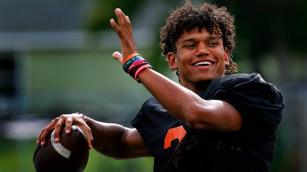 Kennewick High School quarterback Andre Breedlove wears a smile while warming up his throwing arm during a recent practice. The senior has put up impressive numbers in the first three games of the season and has helped the Lions to a 3-0 record.