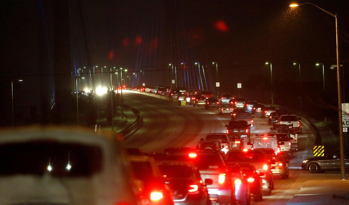 Traffic slows to a crawl across the cable bridge Monday night as snowfall creates hazardous driving conditions on the roadways across the Mid-Columbia. Washington State Patrol troopers investigated 60 collisions Monday between 2 and 6 p.m. in the Tri-City area.