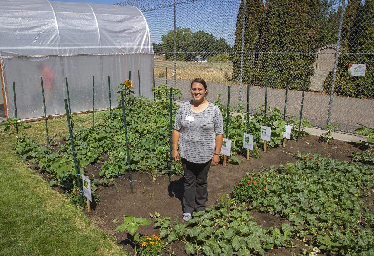 Washington State University Master Gardener Karlee Hodges stands inside the Benton-Franklin Juvenile Justice Center's inmate garden. Hodges is a lead mentor at the garden who helps plan, design and educate about the different gardens.