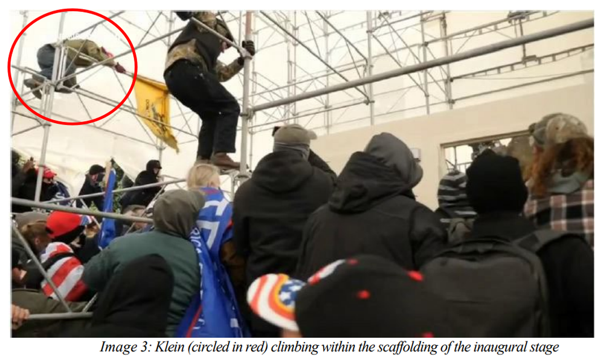 Matthew Klein, of Pendleton, Ore., is seen attempting to scale the scaffolding at the U.S. Capitol Building during the Jan. 6 riot.