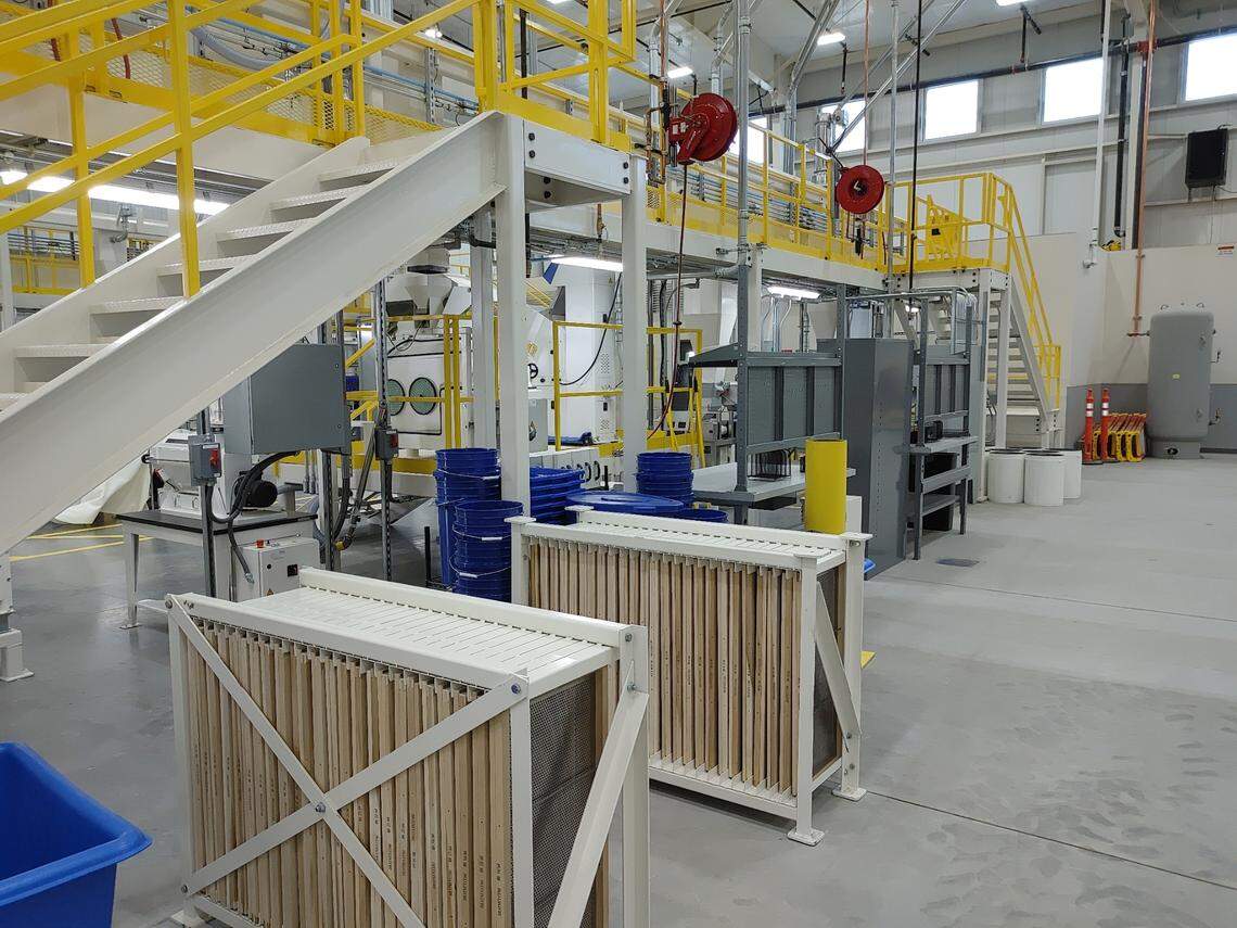 A pair of white cabinets hold screens are used to sort smaller vegetable seeds by size on the way to being packaged and delivered to growers.