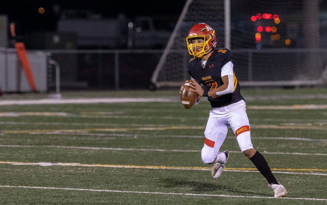Kamiakin senior Henry Mercado looks down the field to pass to Braves wide receiver Aidan Canada during the 1st quarter of the playoff game against the North Creek Jaguars in Kennewick. The Braves won 56-21.
