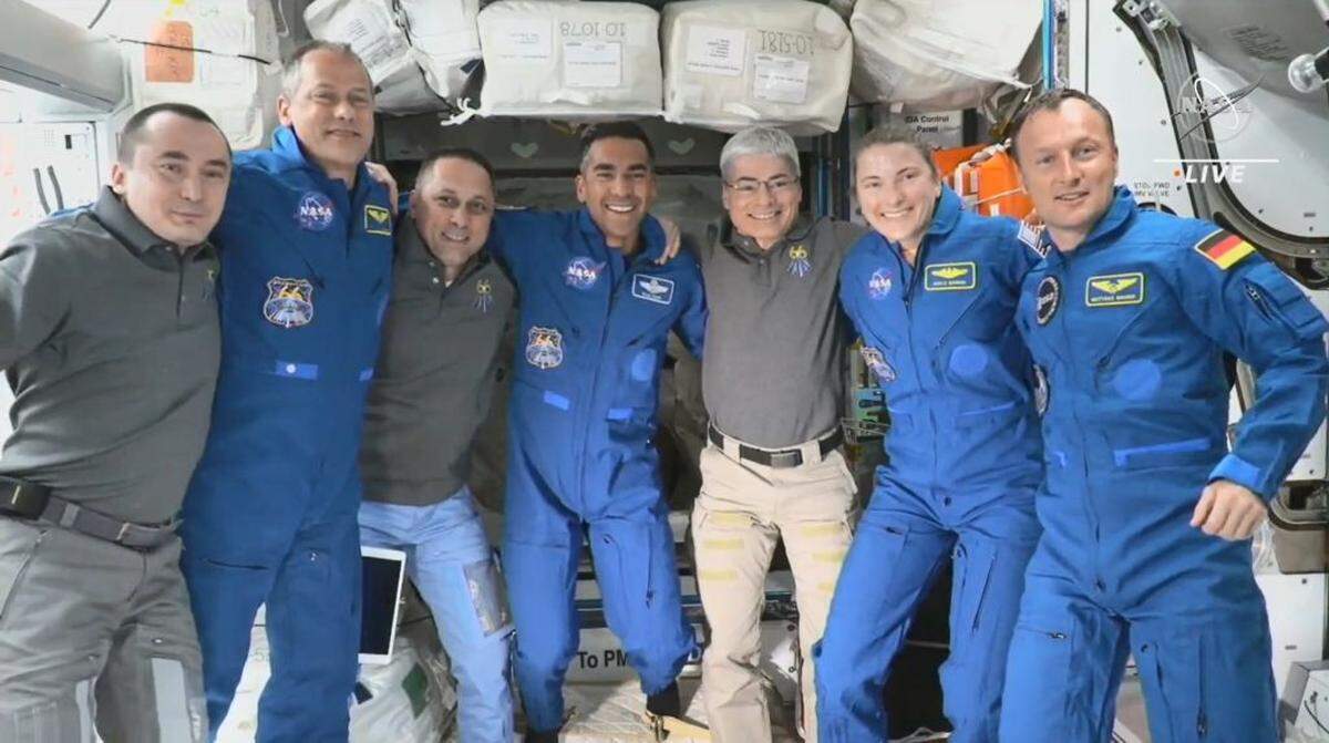 The seven astronauts aboard the International Space Station lined up for a photo just after the arrival of SpaceX Crew-3 Thursday as seen in a screenshot from NASA live video.