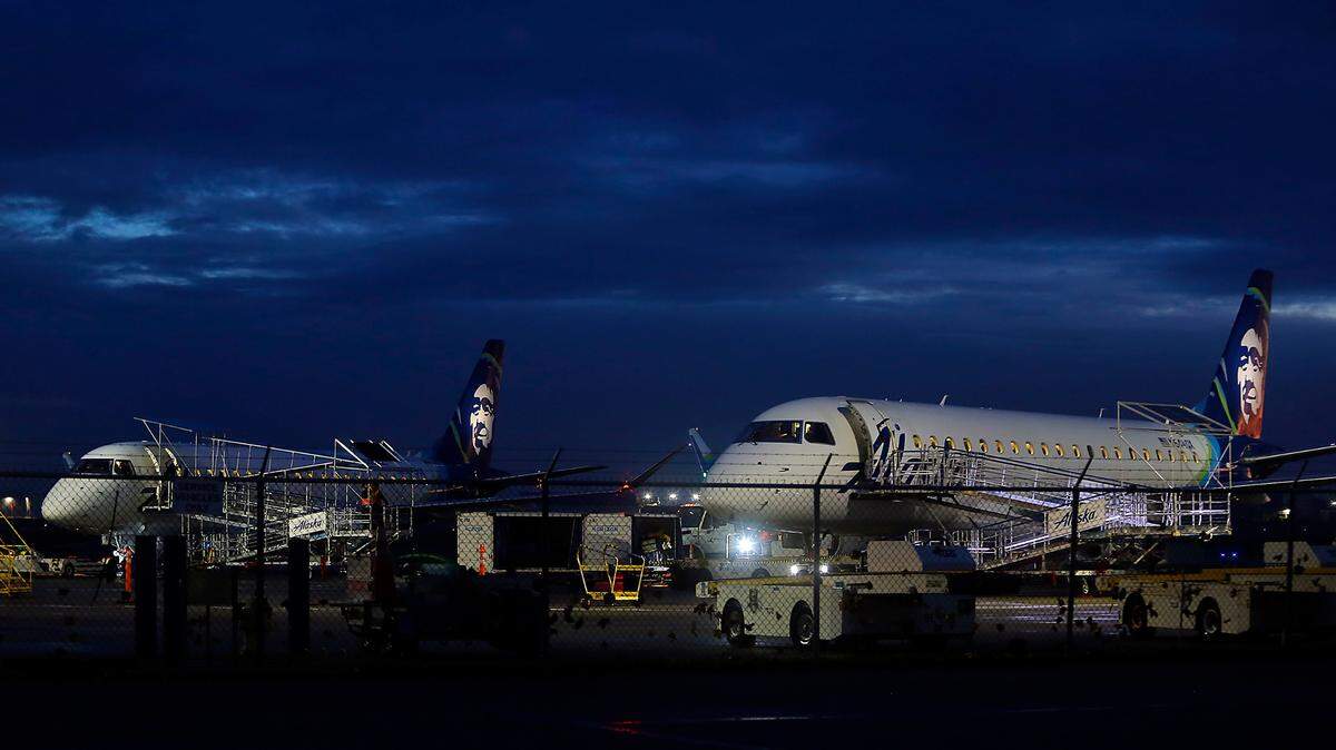A pair of Alaska Airlines passenger jets sit on the tarmac in Wednesday’s predawn at the Tri-Cities Airport in Pasco. An FAA computer glitch temporarily grounded flights across the nation and caused a ripple effect of delays for air travelers.