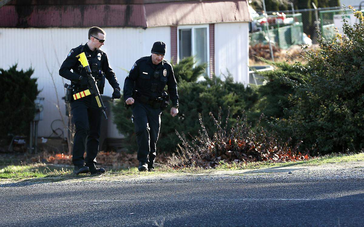 Kennewick police officers search the residential area on West 24th Avenue just west of South Ely Street Tuesday afternoon for a driver that failed to pull over for a traffic stop then ran away after crashing the car he was driving.