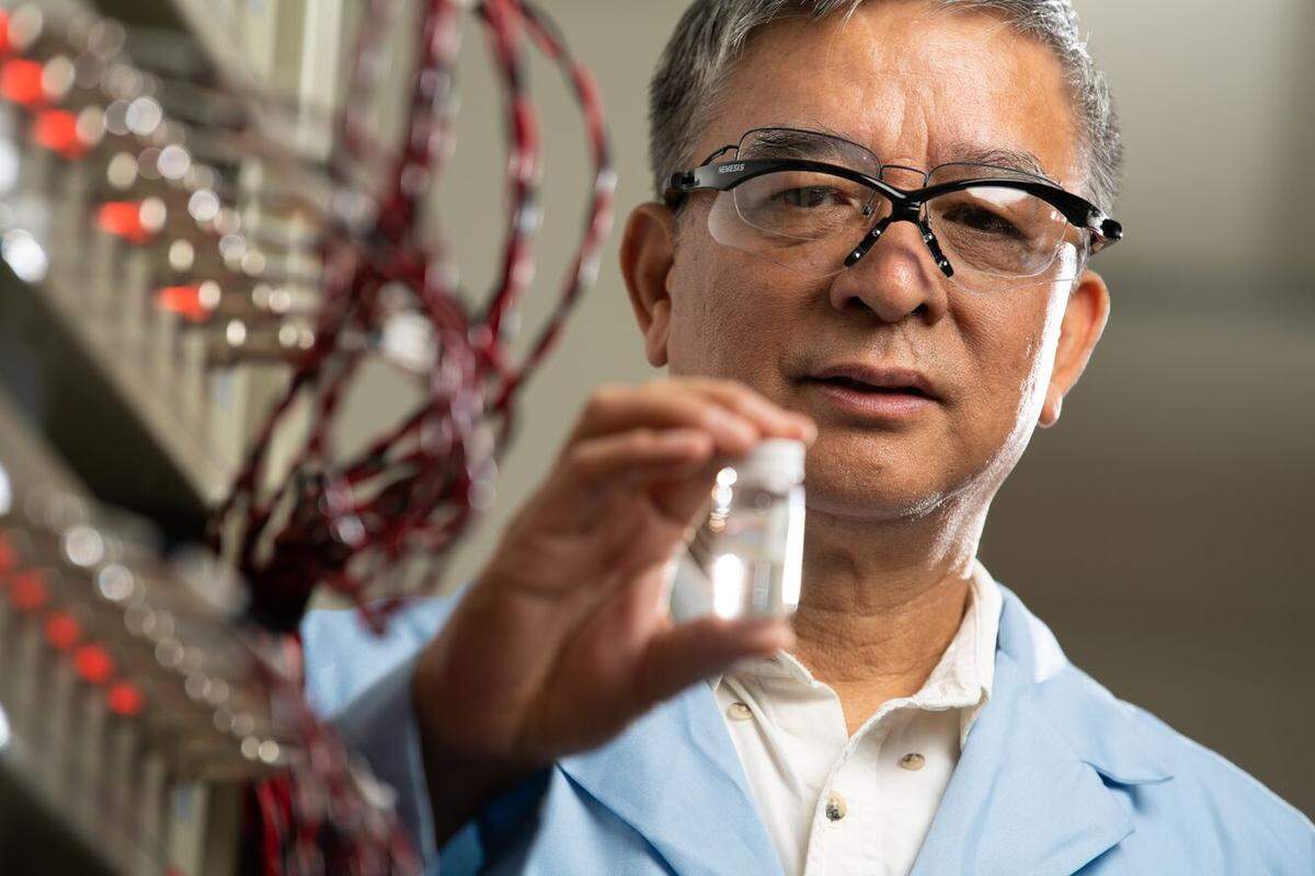 Jason Zhang holds a vial of material specially created to store energy. Zhang, a materials scientist, has worked to make new technologies available more quickly. This is his 12th year on the Clarivate Highly Cited Researchers List.