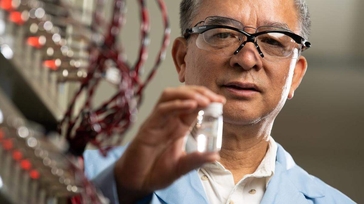 Jason Zhang holds a vial of material specially created to store energy. Zhang, a materials scientist, has worked to make new technologies available more quickly. This is his 11th year on the Clarivate Highly Cited Researchers List.