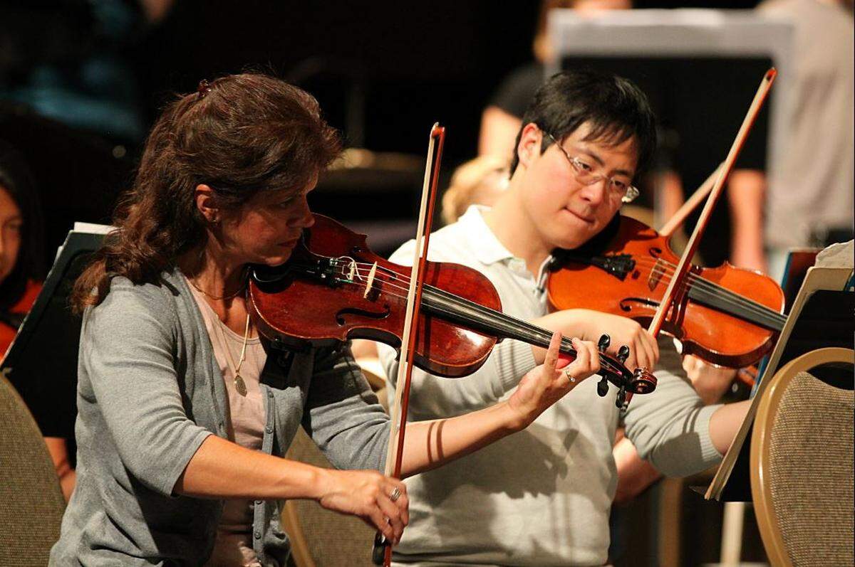Violinists with Mid-Columbia Symphony rehearse in 2012.