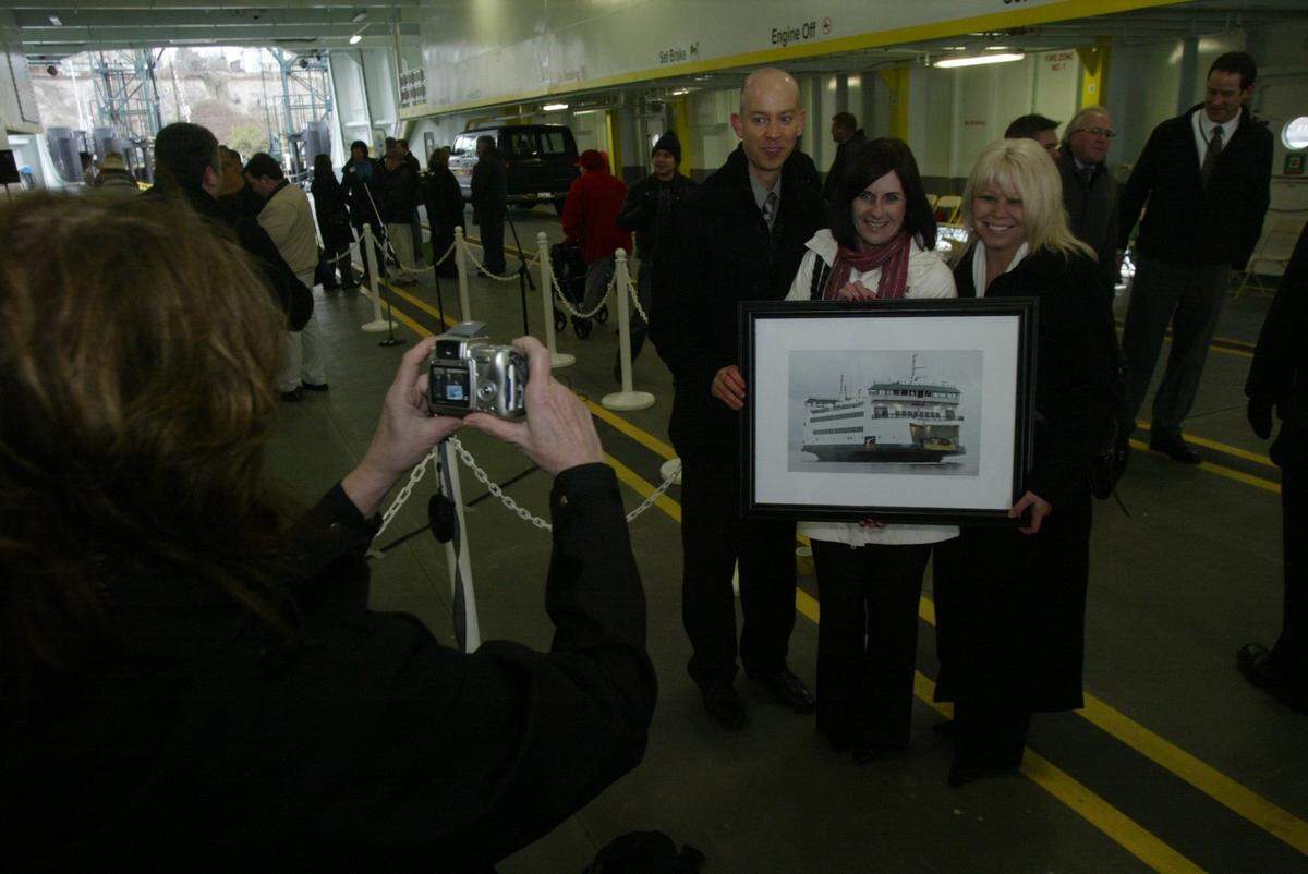 Kennewick city manager Marie Mosley, center, accepted a framed photograph of a new ferry named “Kennewick” in 2012.