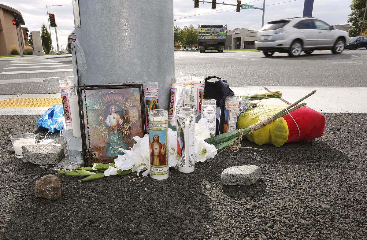 This roadside memorial of flowers, candles, balloons and a baseball hat is near where Leonel Birrueta, 31, of Kennewick, was killed on his moped at West Clearwater Avenue at Edison Street. Katie Summers, 28, is charged with DUI and hit and run from a fatal collision.