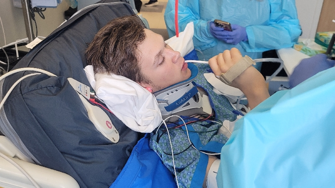David Sample, 16, has regained some use of his right hand after a bad landing doing flips on a trampoline. He is in an intensive care unit at Harborview Medical Center in Seattle.