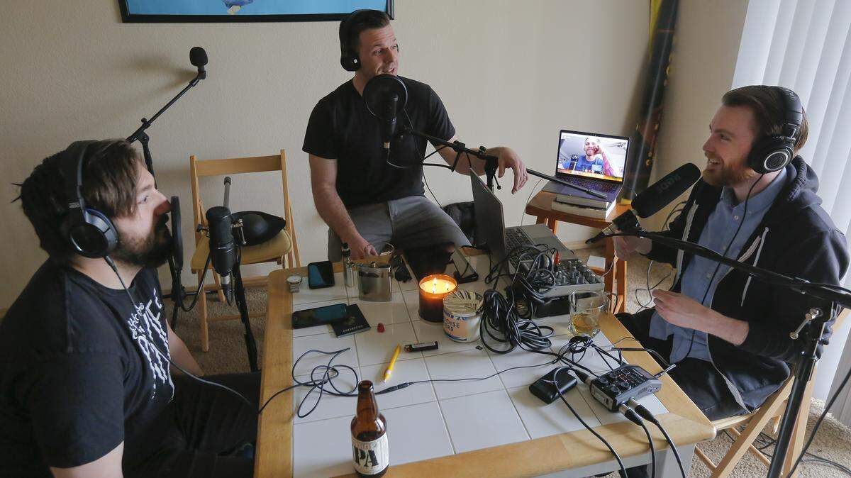 Friends Jeffrey Graham, left, Brian Griffin, center, Joel Petersen, right, and on the laptop Brandon Gale record their podcast Vanilla Sunday recently in Pasco.  Gale lives in Portland but joins the podcast via Skype.