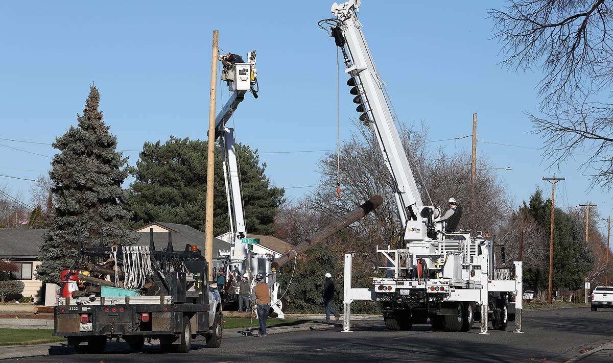 Crews from Richland Energy Services work to restore power Wednesday morning to customers in central Richland after power outages were caused by an overnight windstorm that roared across the Mid-Columbia region.