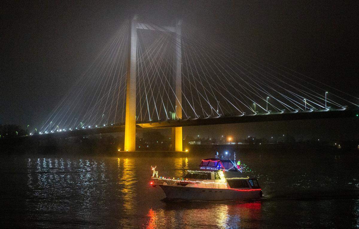 A dozen boats decked out with holiday lights cruised the Columbia River to keep an annual Tri-Cities tradition alive after the Clover Island Yacht Club had to call off the official parade started in 1964.