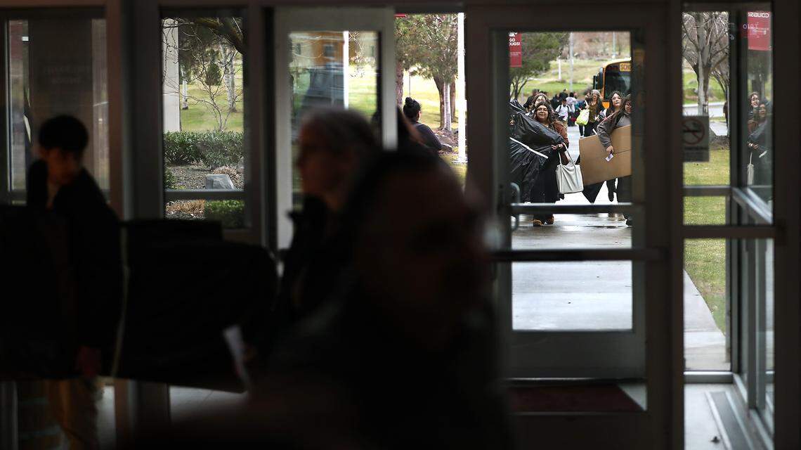 Students participating in the 70th annual Mid-Columbia Regional Science and Engineering Fair carry their project into the CIC building at the WSU-Tri-Cities campus in Richland.