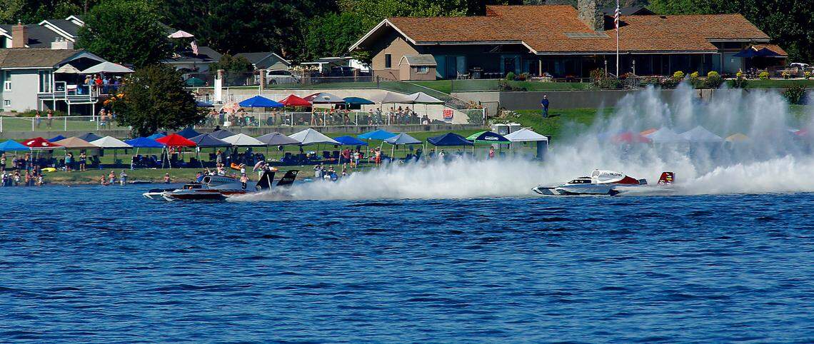 Corey Peabody in the U-9 Pinnacle Peak Consulting unlimited hydroplane passes his teammate J. Michael Kelly in the U-8 Miss Tri-Cities on the back stretch of the Columbia Cup race course to claim victory in the Columbia Cup final race.