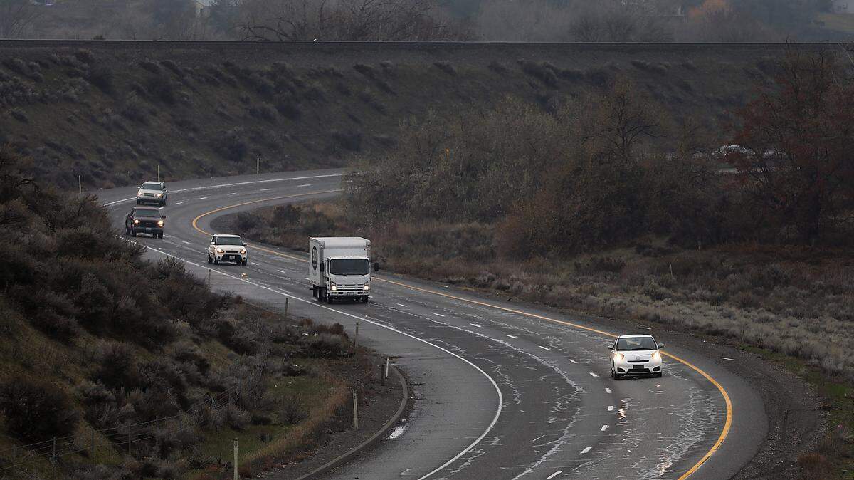 Cars drive on a curving section of Highway 240 toward Interstate 182.
