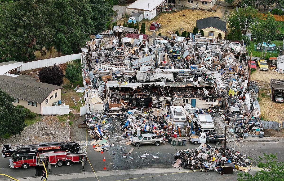 Richland firefighters remain on the scene Friday morning at the site of Thruday's two-alarm fire at the "junkyard" house at 2100 Pullen St. in Richland. 