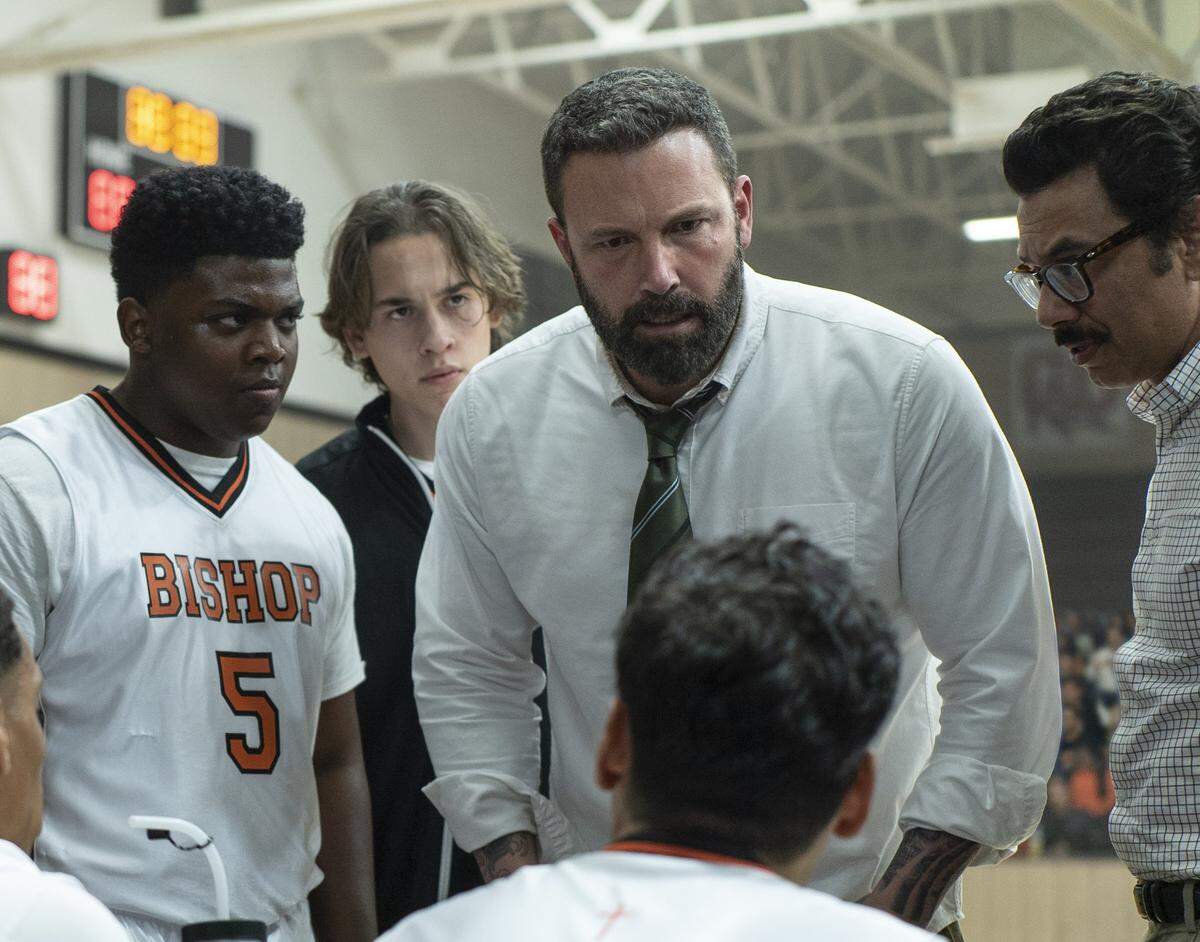 This image released by Warner Bros. Pictures shows Charles Lott Jr., left, Ben Affleck and Al Madrigal in a scene from “The Way Back.” (Richard Foreman/Warner Bros. Pictures via AP)