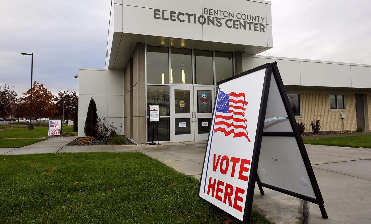 Signs outside the Benton County Elections Center help guide voters to the outdoor drop box and offices at the building in Kennewick.